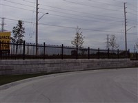 IRON EAGLE  FENCE ON RETAINING WALL